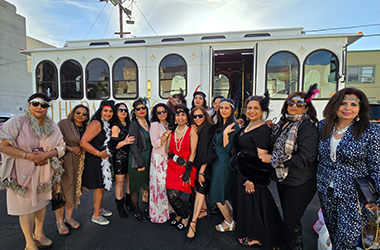 A white vintage-style Parlor Car Trolley with ladies for birthday parties