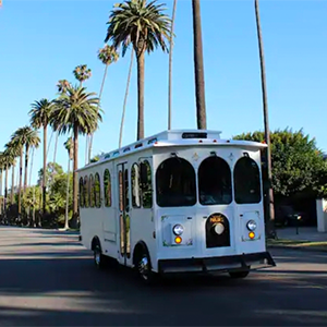 A white vintage-style Parlor Car Trolley on road